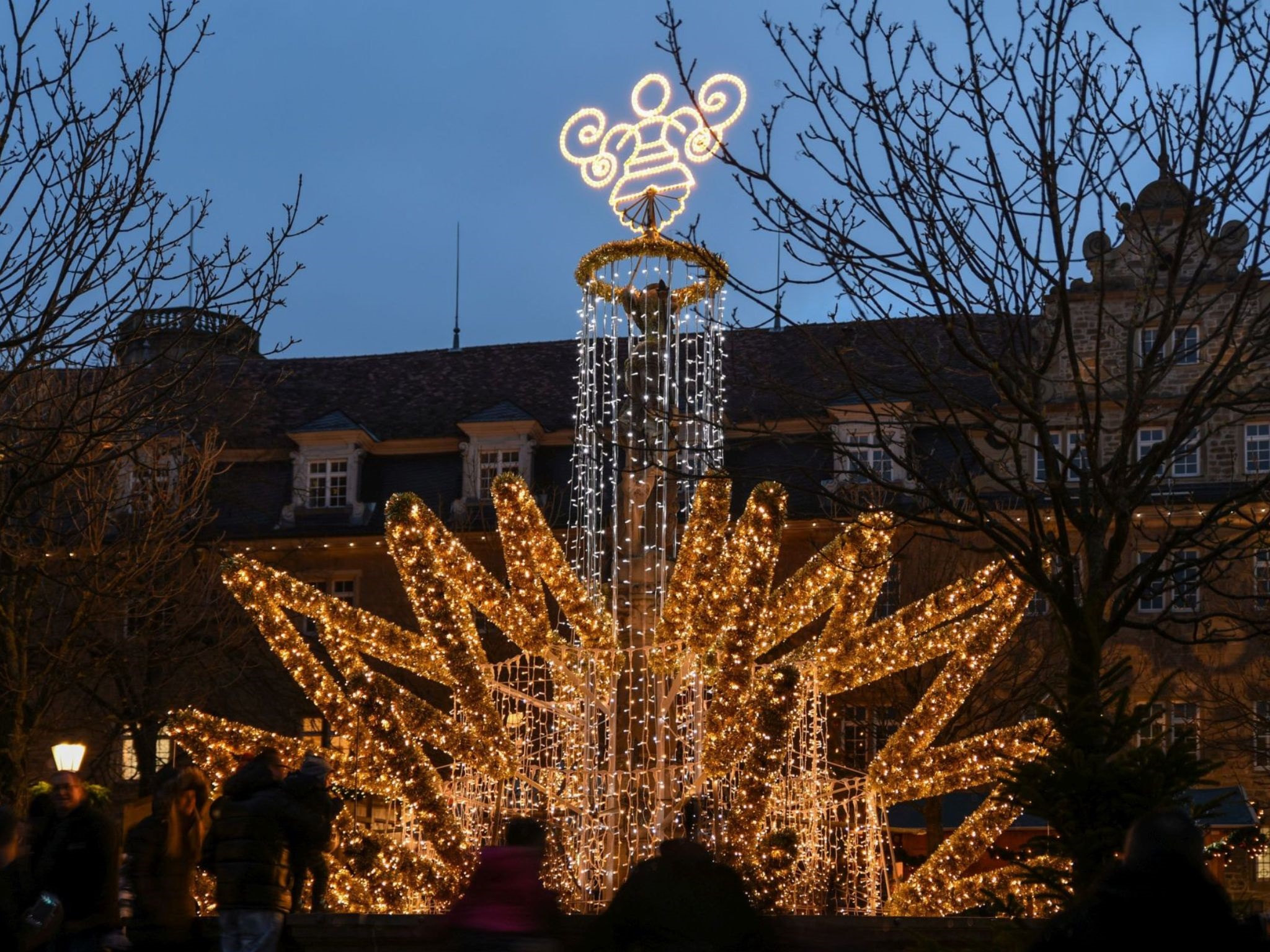 Der geschmückte Brunnen leuchtet auf dem Marktplatz.